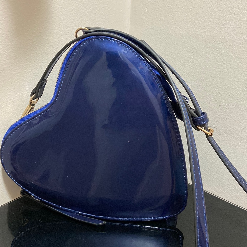 Lightly worn heart shaped crossbody bag.